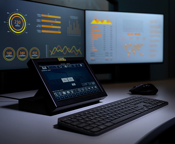 Control room workplace with smartTOUCH Flex, keyboard and multiple screens that are controlled by a KVM switch dual monitor